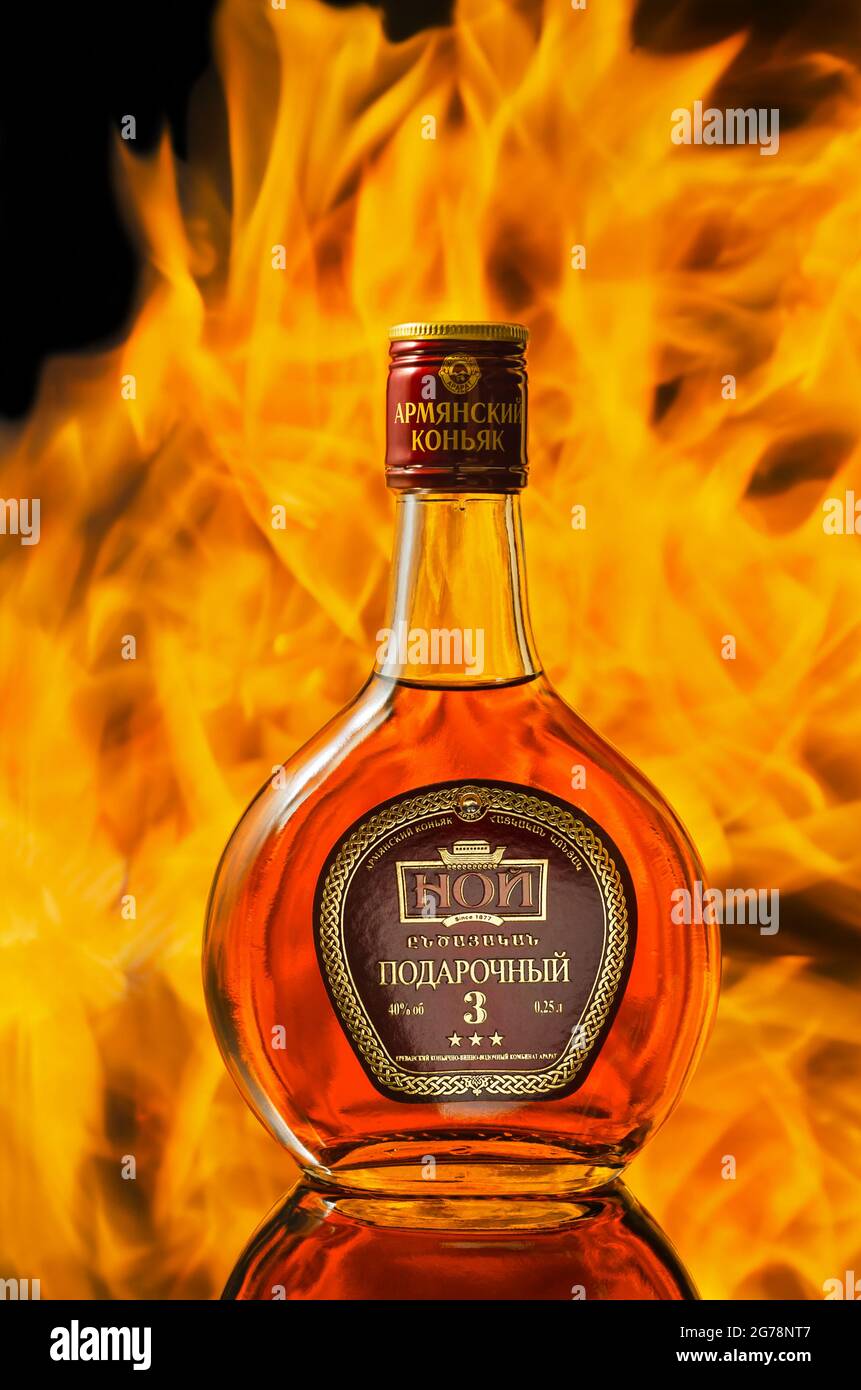 A bottle of Armenian cognac, photographed against the background of a flame. Dimitrovgrad, Russia, August 8, 2018 Stock Photo