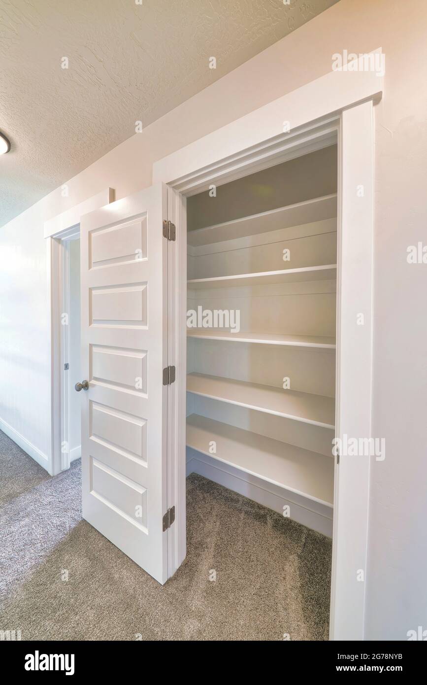 Linen closet of house with wide shelves for storing organization and