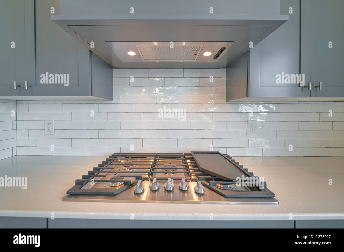 Cooktop with burners fixed on the kitchen countertop of home with