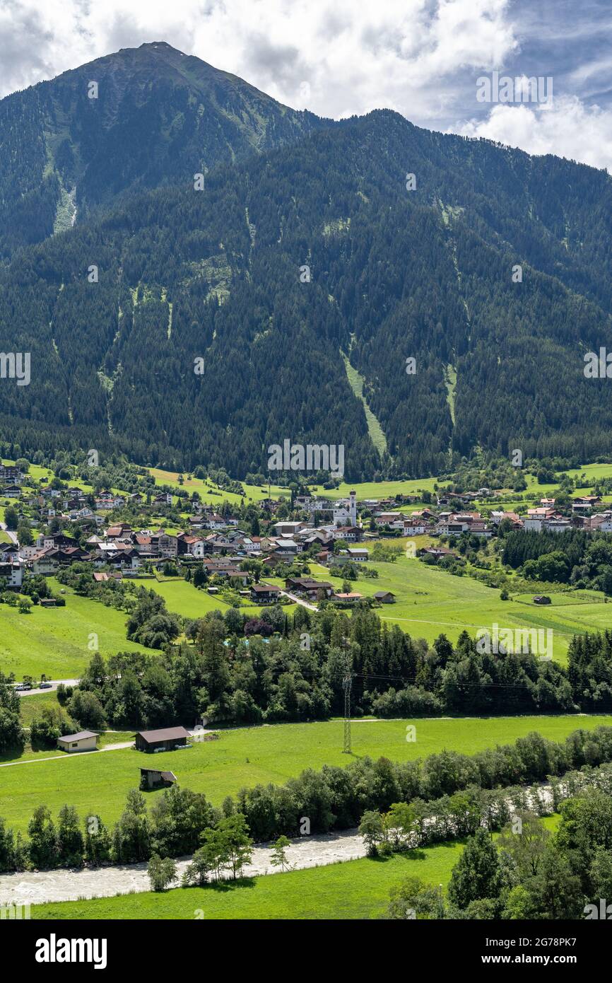 Europe, Austria, Tyrol, Ötztal Alps, Ötztal, Sautens, view from a vantage point in the light mountain forest to the village of Sautens in the front Ötztal and the mountain scenery in the background Stock Photo
