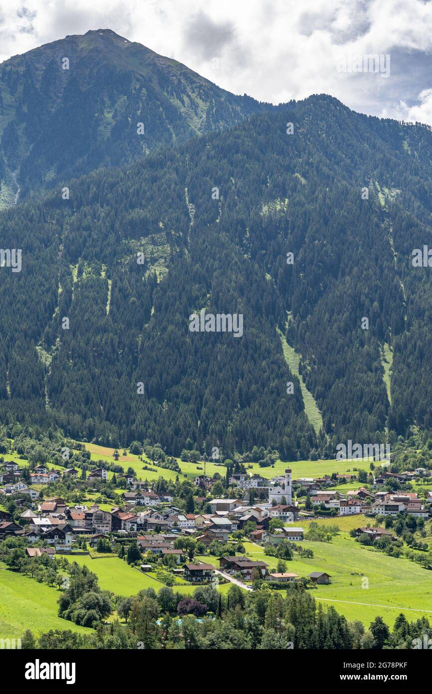 Europe, Austria, Tyrol, Ötztal Alps, Ötztal, Sautens, view from a vantage point in the light mountain forest to the village of Sautens in the front Ötztal and the mountain scenery in the background Stock Photo