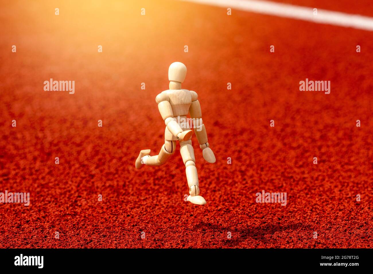 Running Inspired Object Wooden figure running on the stadium track. Healthy life concept Stock ...