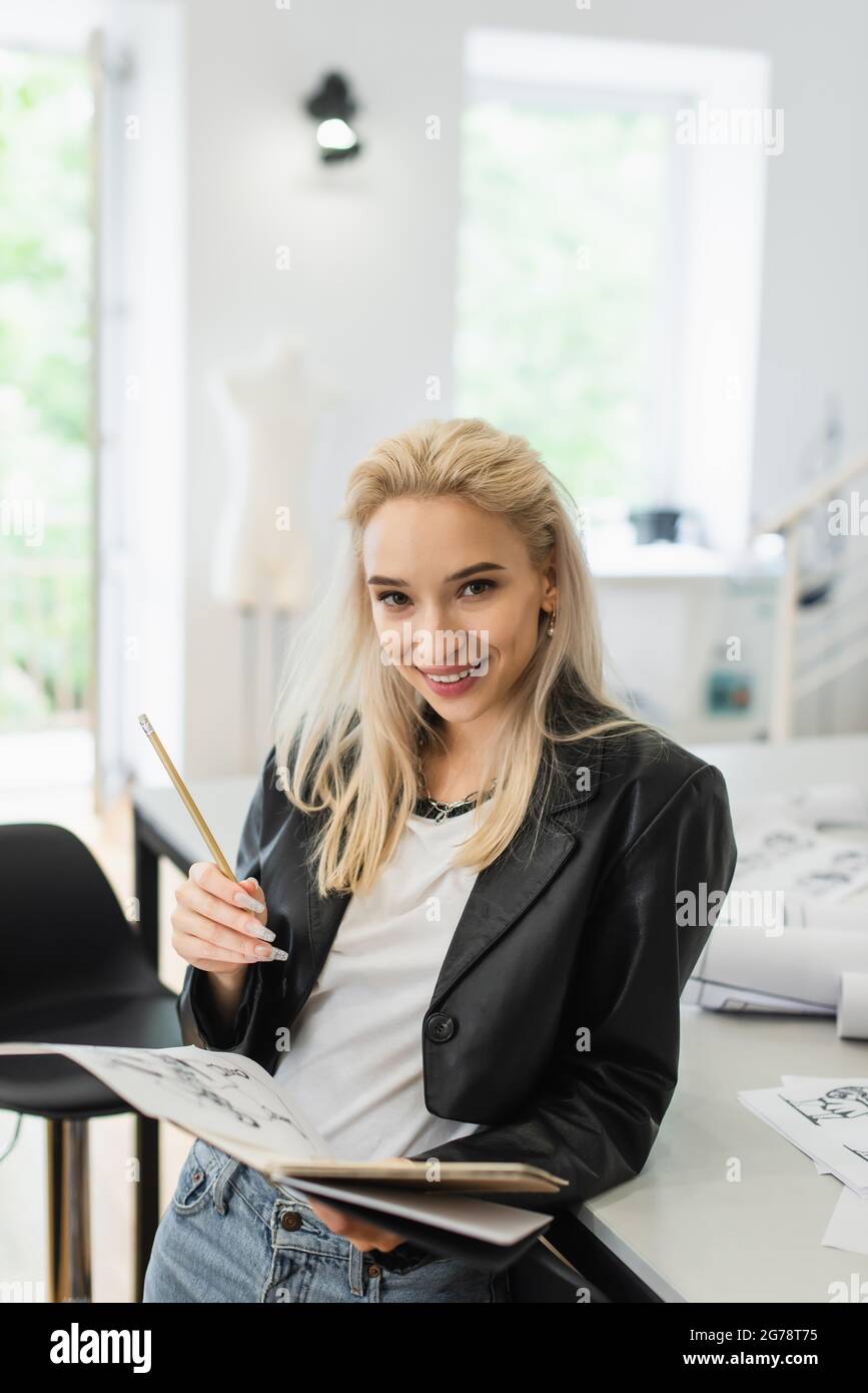Blonde fashion designer drawing clothes hi-res stock photography and ...