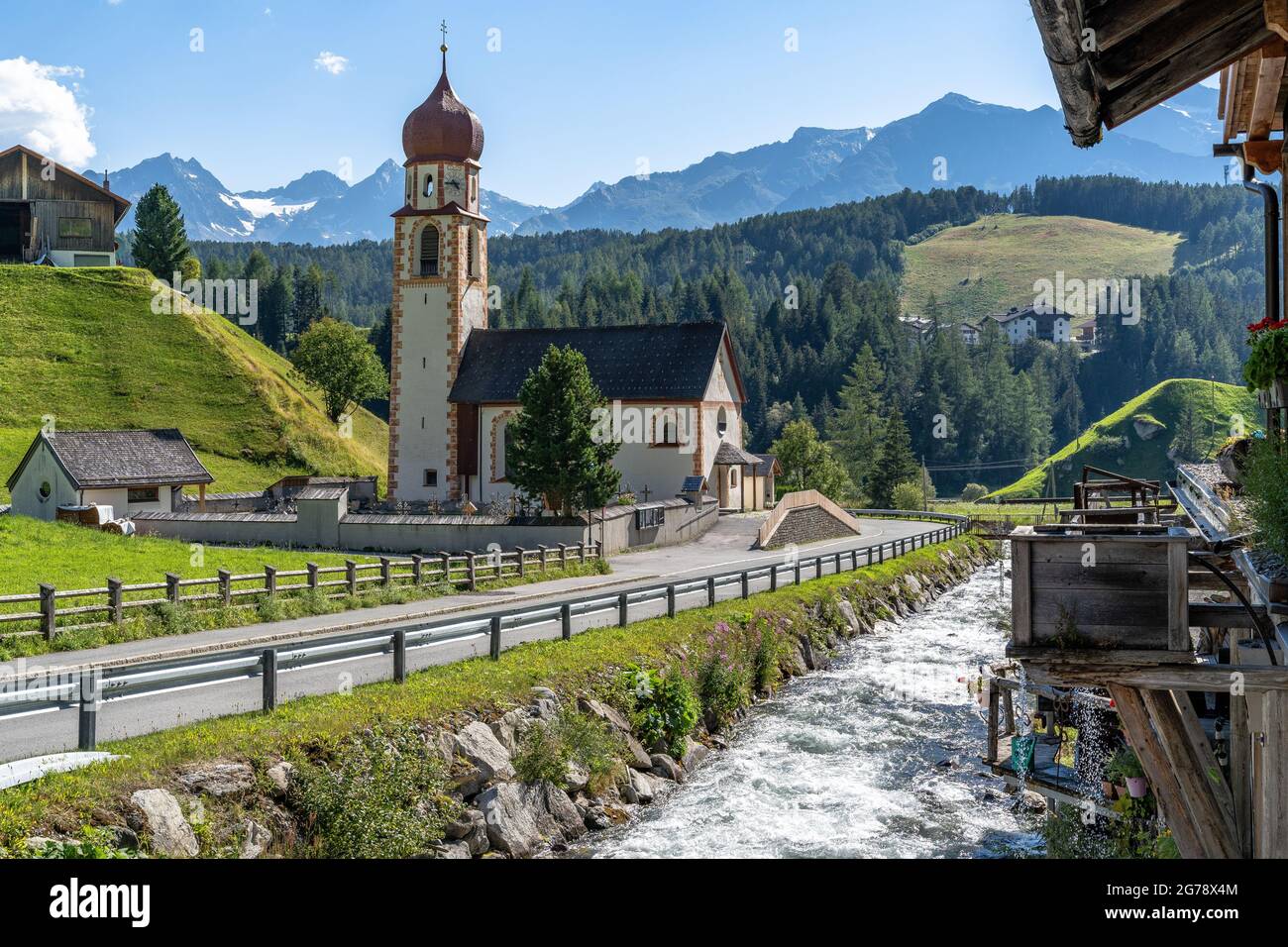 Europe, Austria, Tyrol, Ötztal Alps, Ötztal, Niederthai, view of the parish church of Saint Antonius and the old village smithy Stock Photo