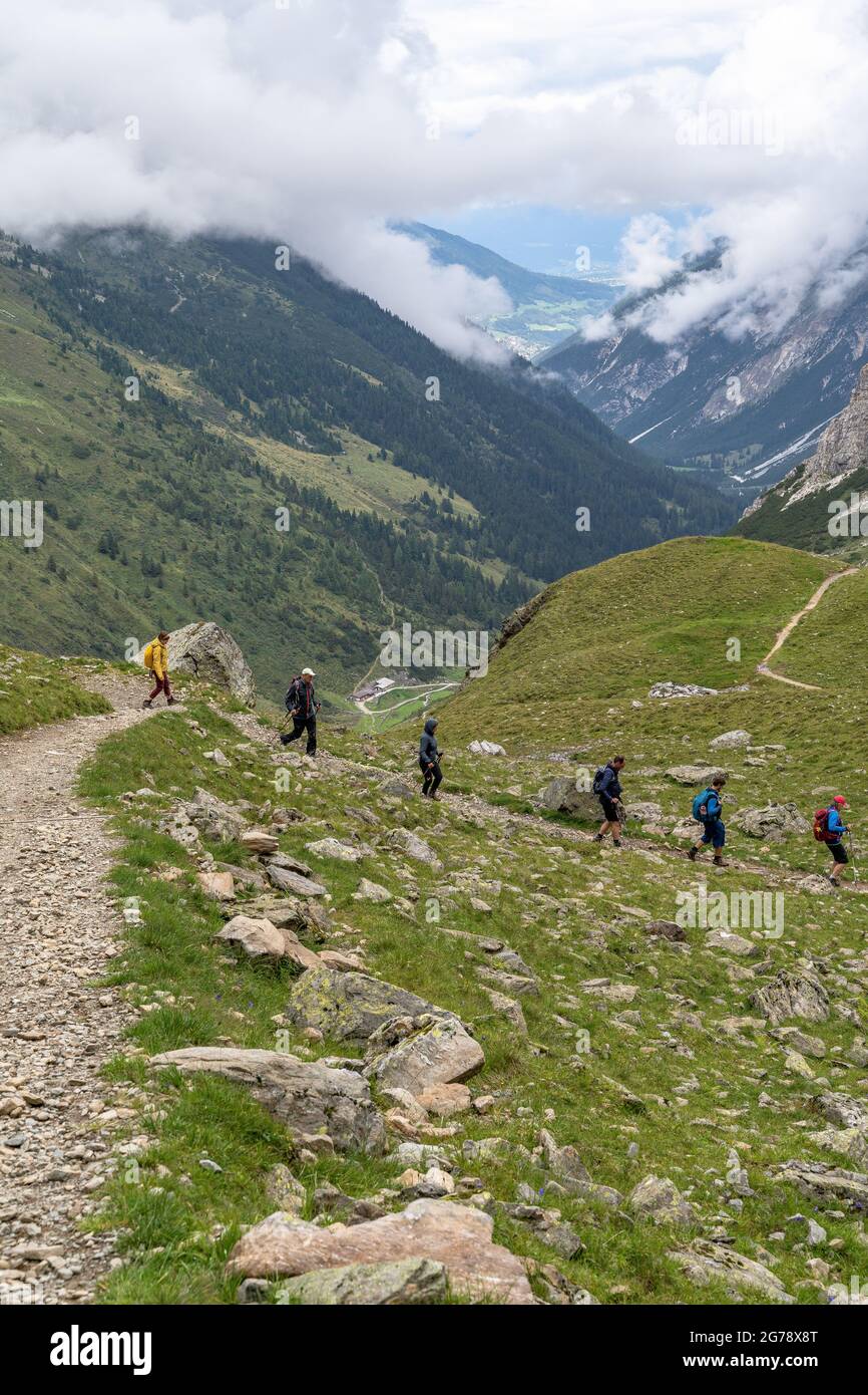 Europe, Austria, Tyrol, Stubai Alps, Pinnistal, hiking group on the descent from the Innsbrucker Hut into the Pinnistal Stock Photo