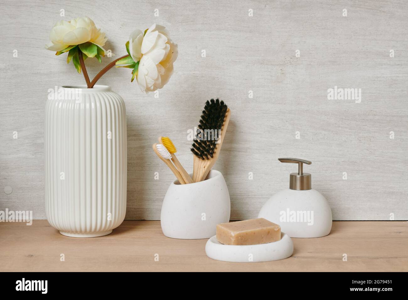 Group of bodycare items against white wall in bathroom Stock Photo