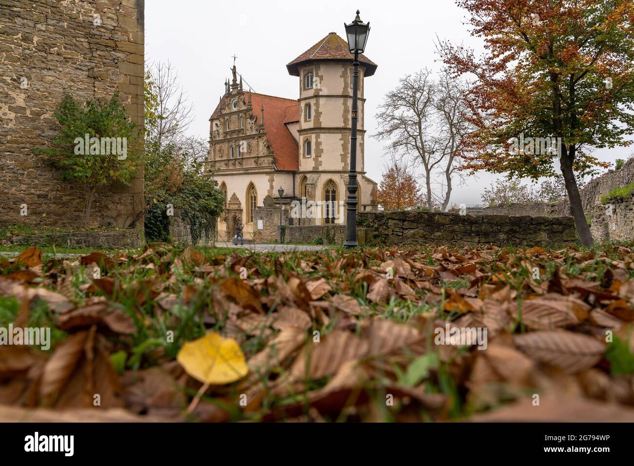 Europe, Germany, Baden-Wuerttemberg, Neckar Valley, Neckarwestheim, Liebenstein Castle, view over the leaf-covered ground to the castle chapel Stock Photo