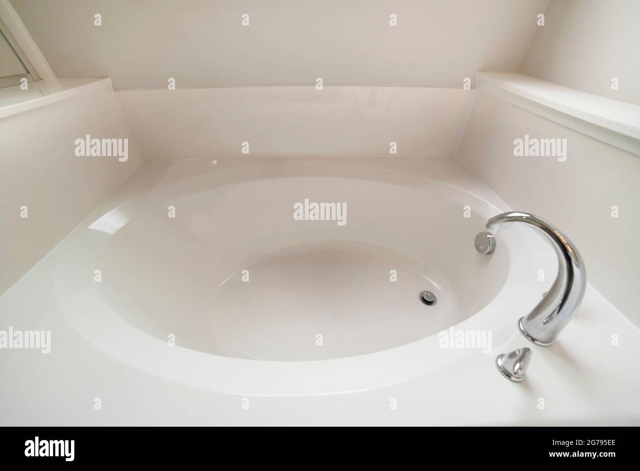 Interior of a bathroom with bathtub, drainage and faucet Stock Photo Alamy