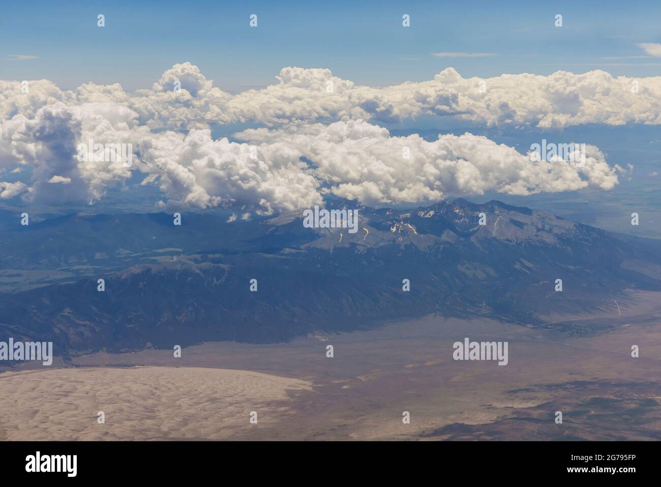 Overview on the airplane of fluffy clouds in scenic landscape of ...