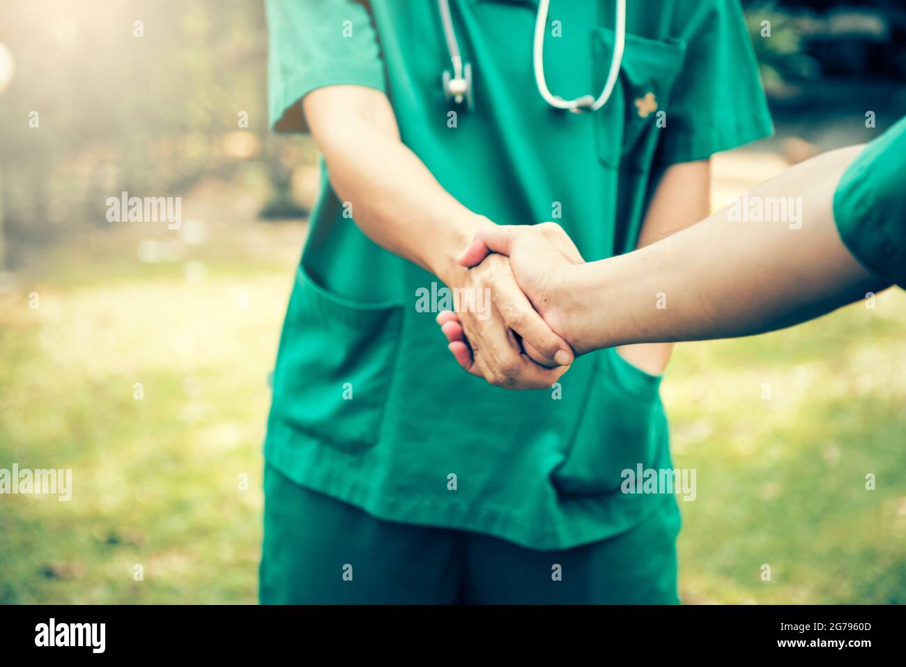 Surgeon medical people handshaking.Cross processing and Split tone instragram like process. Stock Photo