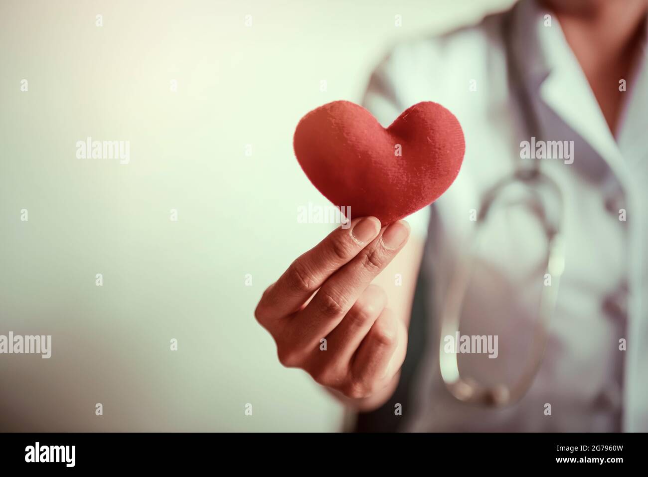 Red heart in nurse's hands.Cross processing and Split tone instragram like process. Stock Photo