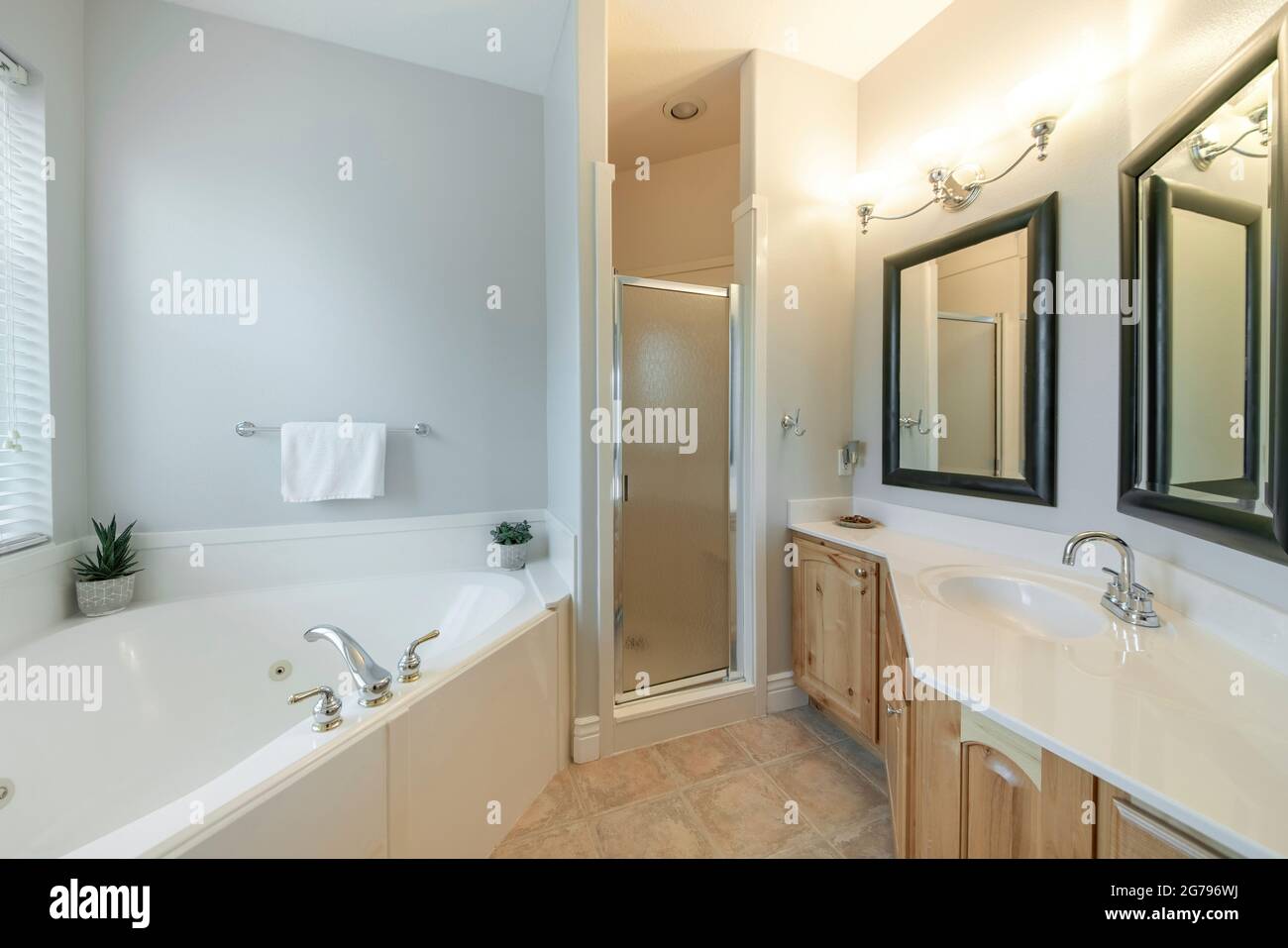 Large bathroom interior with bathtub, sink and shower Stock Photo