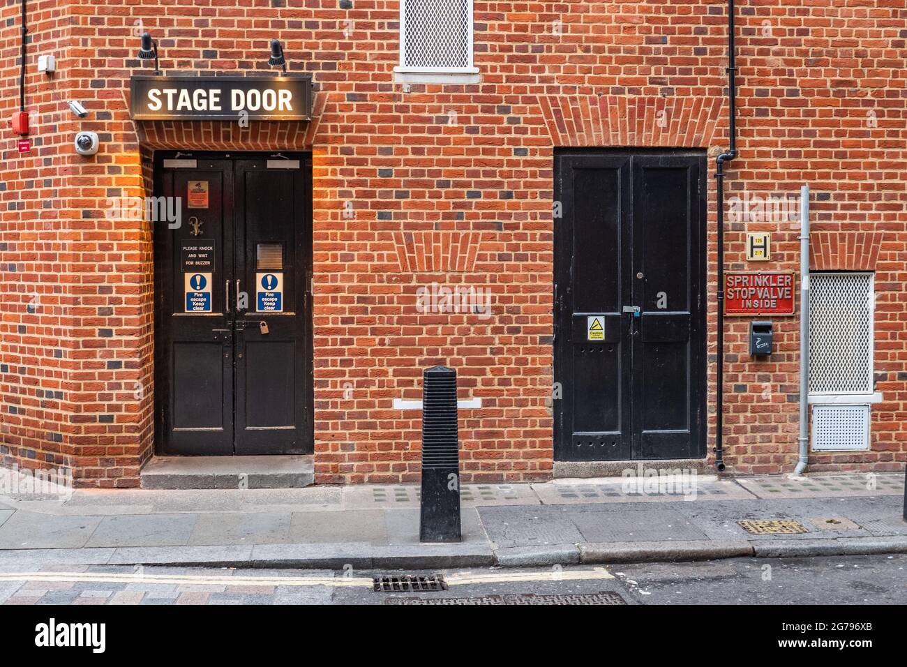 Stage Door, London. A securely closed stage door at the rear of a theatre in the heart of London's West End theater district. Stock Photo