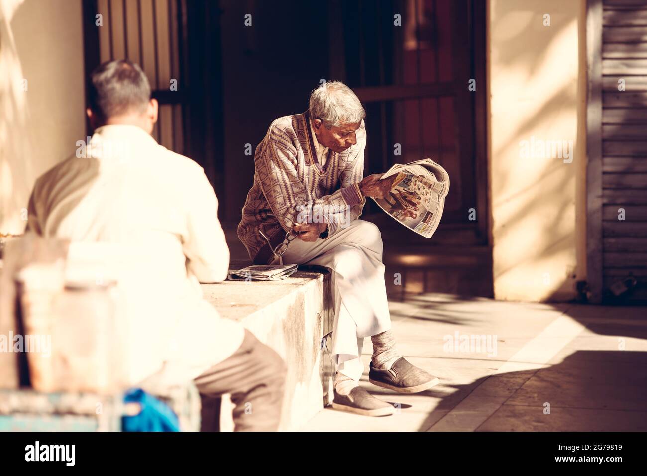 Man reads newspaper Stock Photo