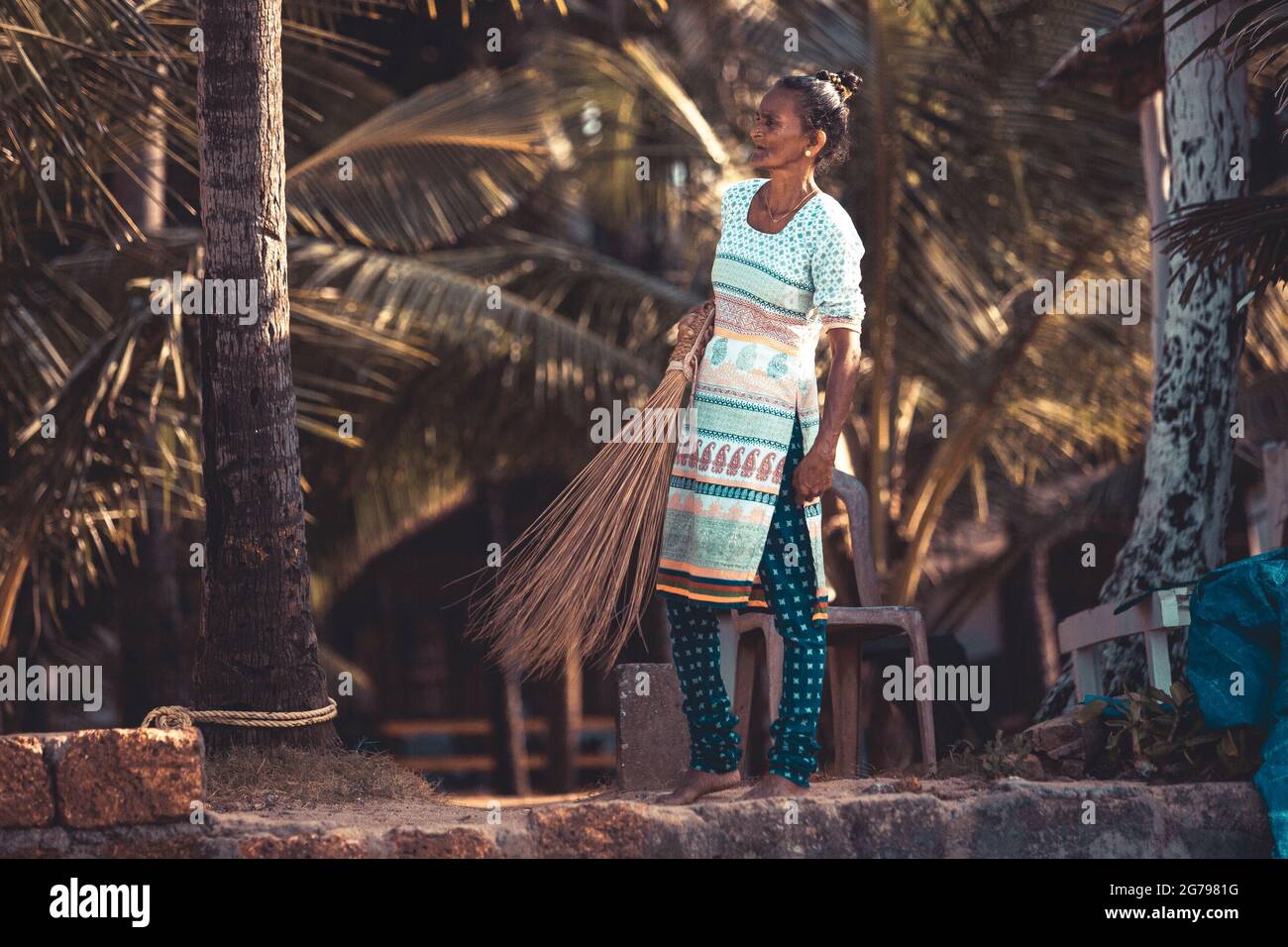 Indian woman with palm fronds Stock Photo