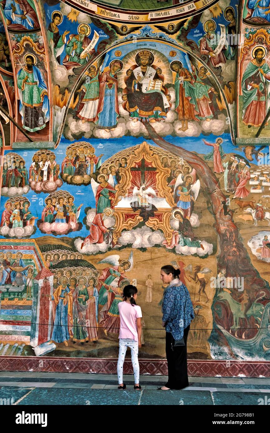 woman and child in front of a mural in Rila Monastery, Bulgaria. Stock Photo