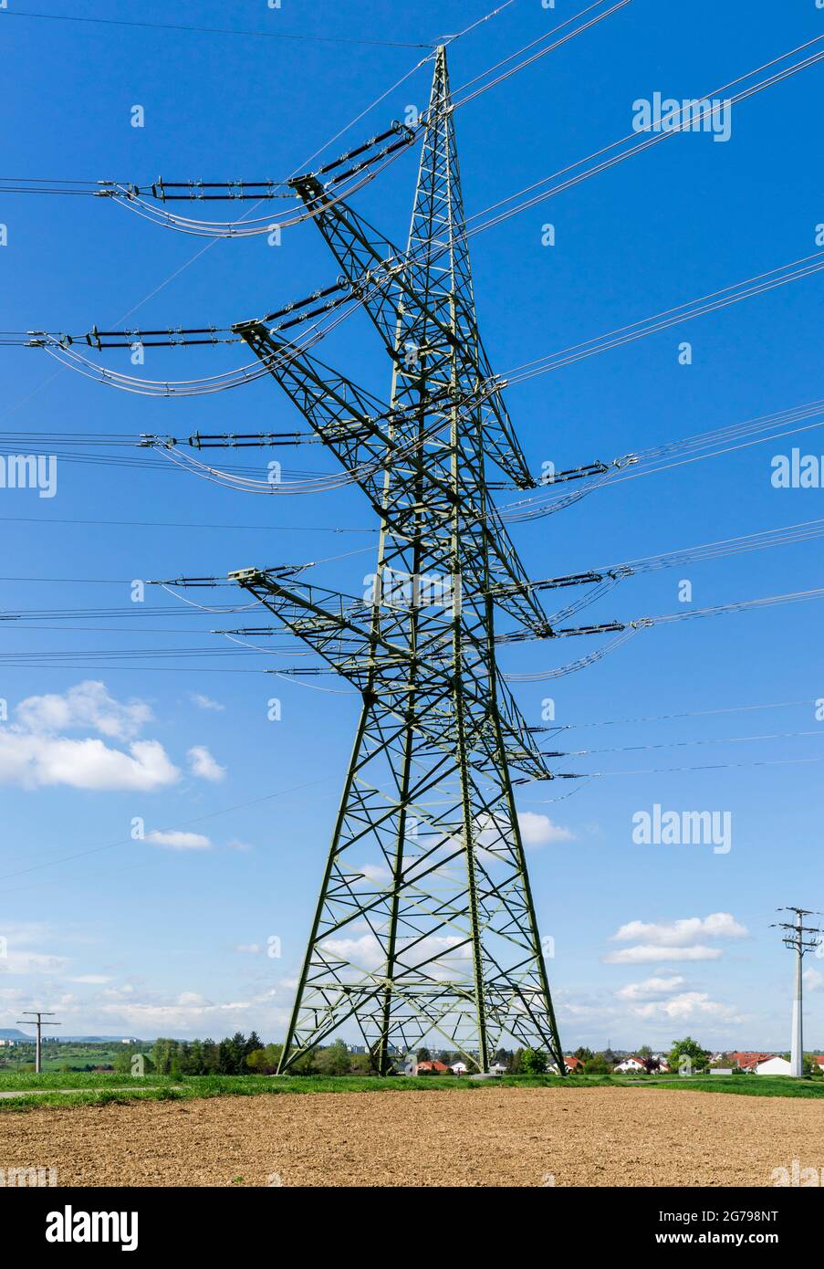 Overhead line mast, high-voltage line in the open field near Reicheneck Stock Photo