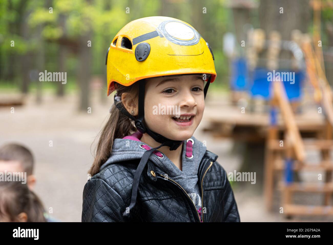 Adventure climbing high wire park little girl on course in mountain