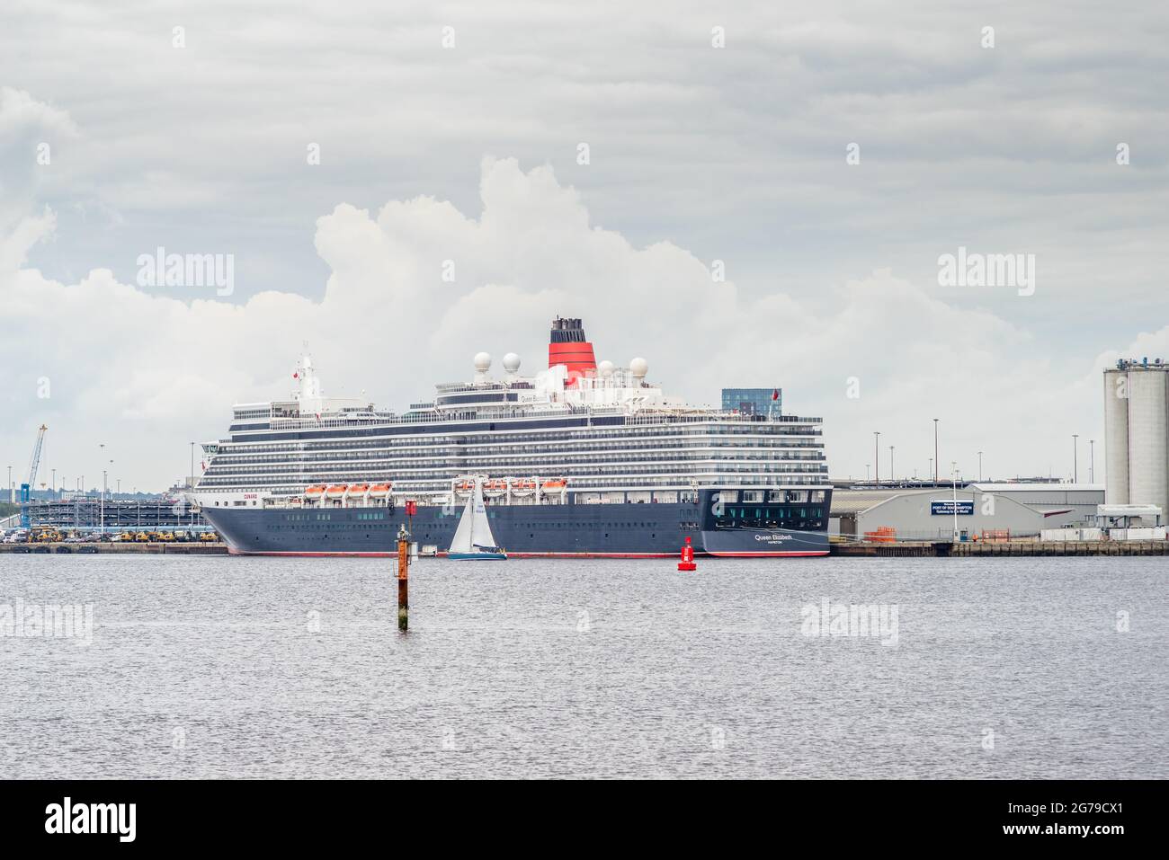Southampton, UK. 8 July 2021. The Cunard Queen Elizabeth cruise ship docked in the Port of Southampton, as seen from Hythe marina,after it returned earlier this week due to staff testing positive for Covid-19 Stock Photo