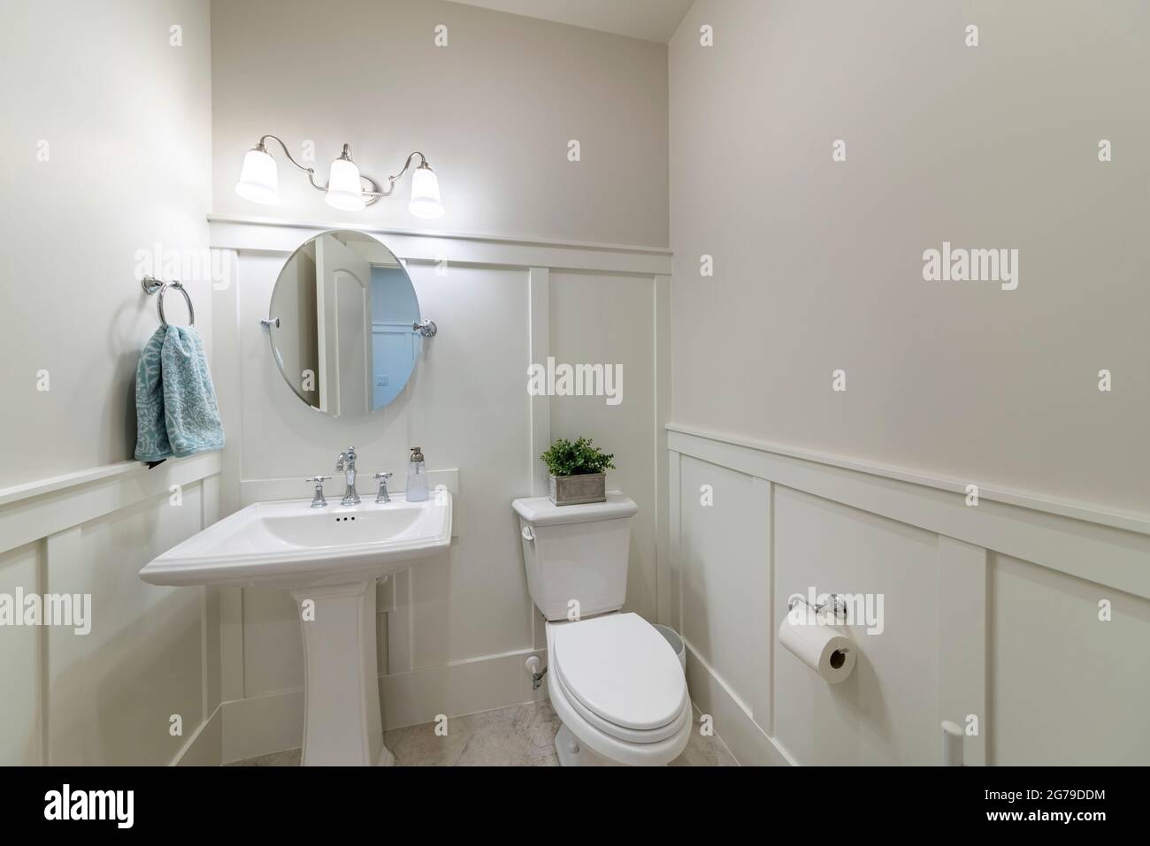 Interior of a powder room with half wooden panel and lights Stock Photo