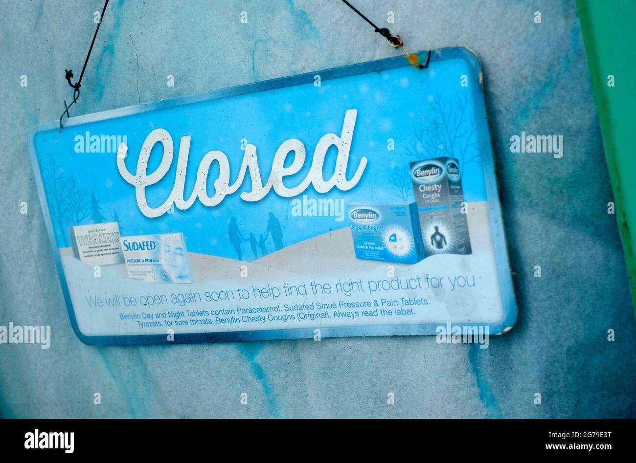 faded closed sign in old chemist shop window, norfolk, england Stock Photo