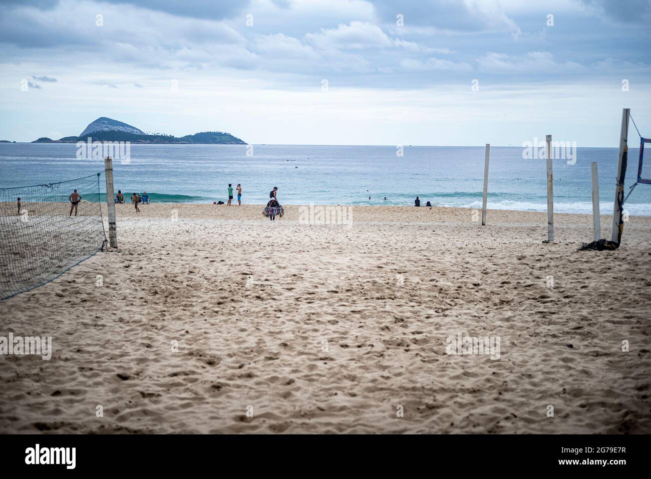 A group of young Brazilians play a game of volleyball at sunset at the Leme end of Copacabana Beach. Stock Photo