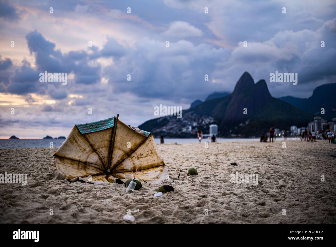 Broken Umbrella at Ipanema Beach with the mountain Dois Irmaos in the Background Stock Photo