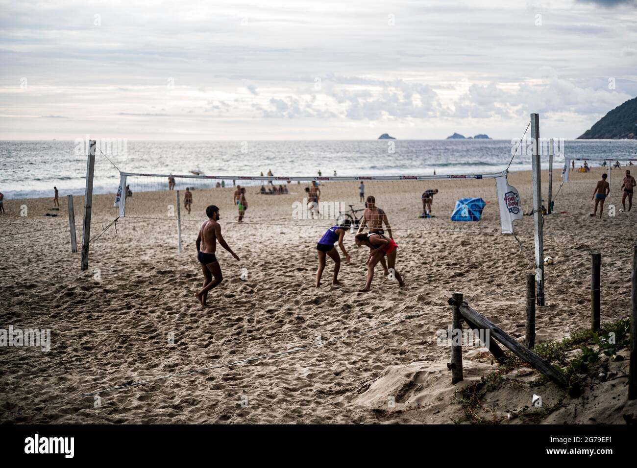 Young Brazilias play a game of futevôlei (footvolley), a sport that combines football/soccer and volleyball, on the beach in Leblon. Rio de Janeiro, Brazil Stock Photo