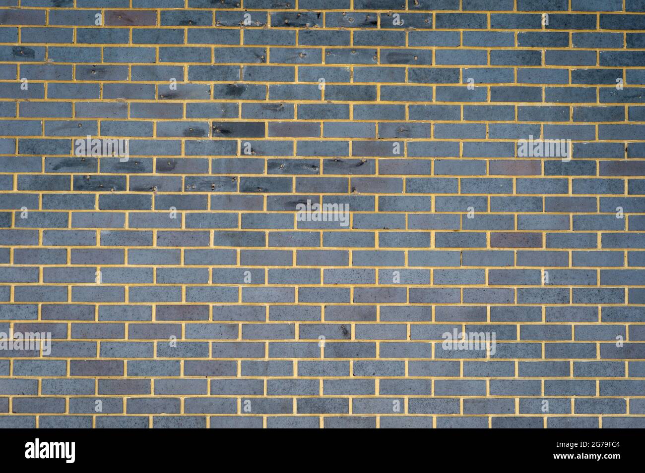 Grey brick external wall, background. Stock Photo