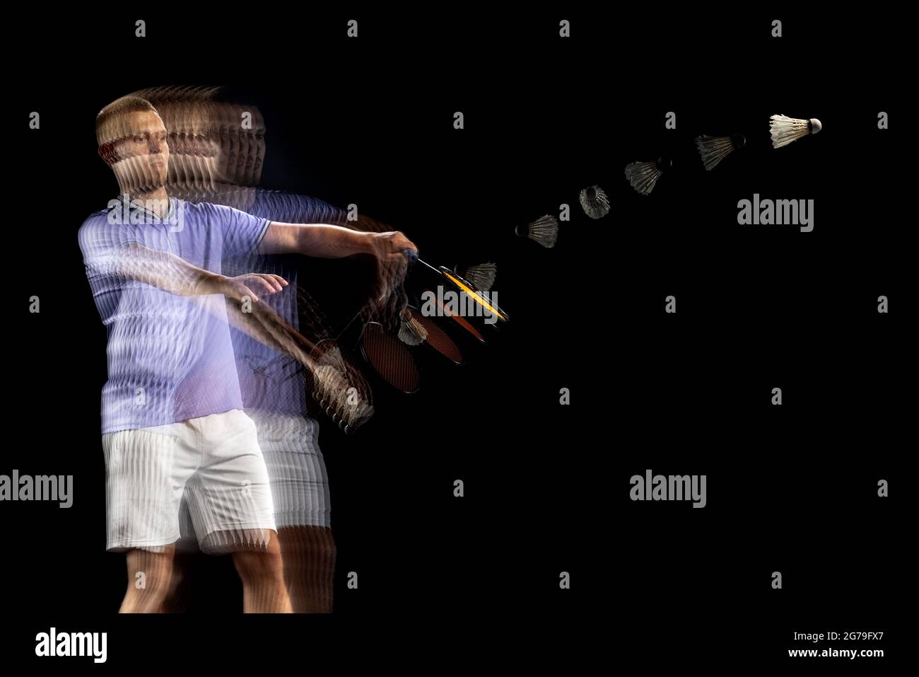 Spectacular trajectory of movement. One young male badminton player ...
