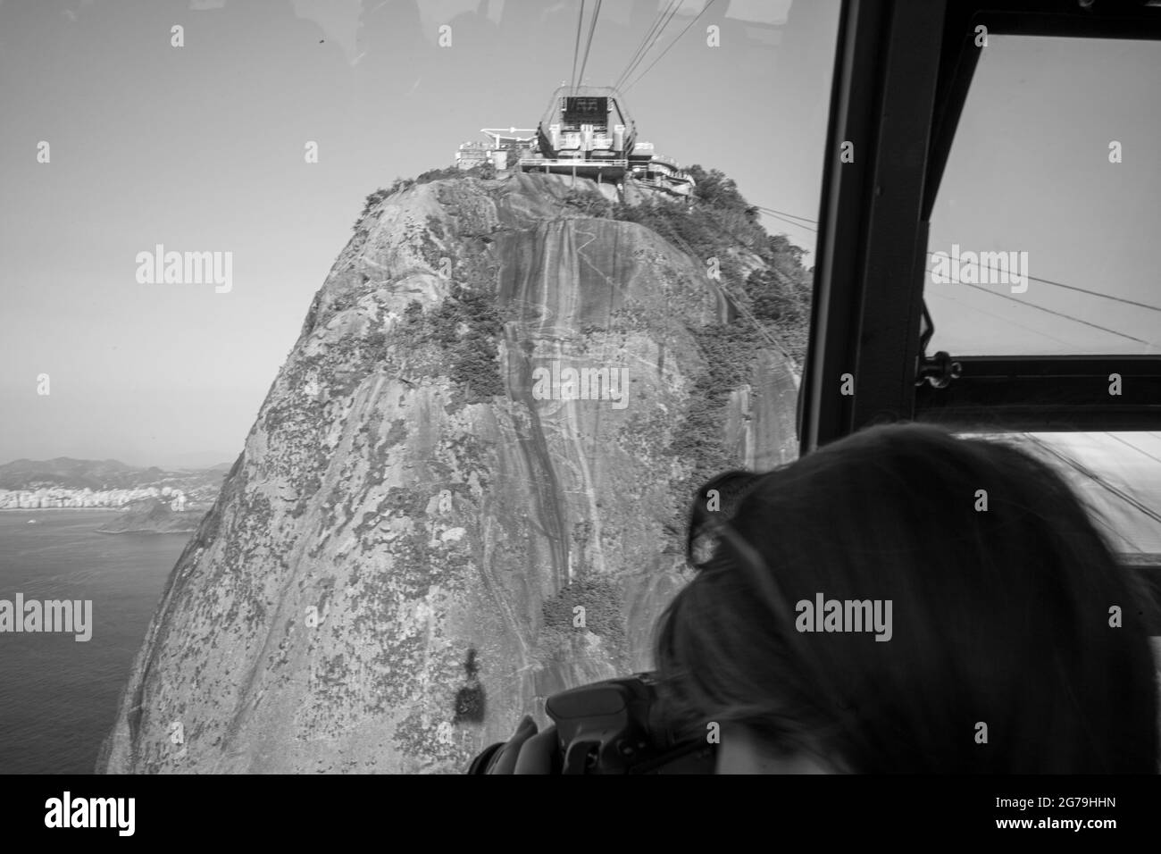 View of the Sugar loaf Mountain from inside the cable car that accesses the upper part of the hill. Stock Photo