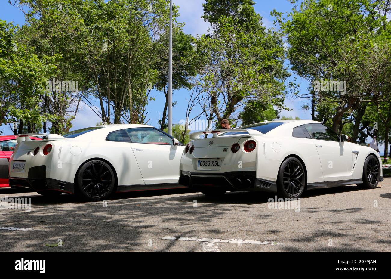 Rear view of two white Nissan Skyline GT-R cars at a Super car day ...