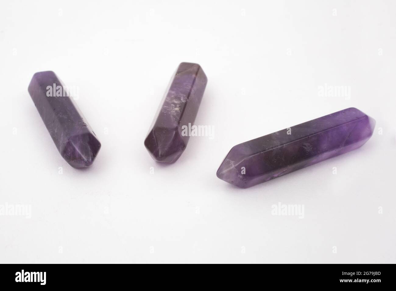 Purple Amethyst points, gemstones used for healing photographed against a white background Stock Photo