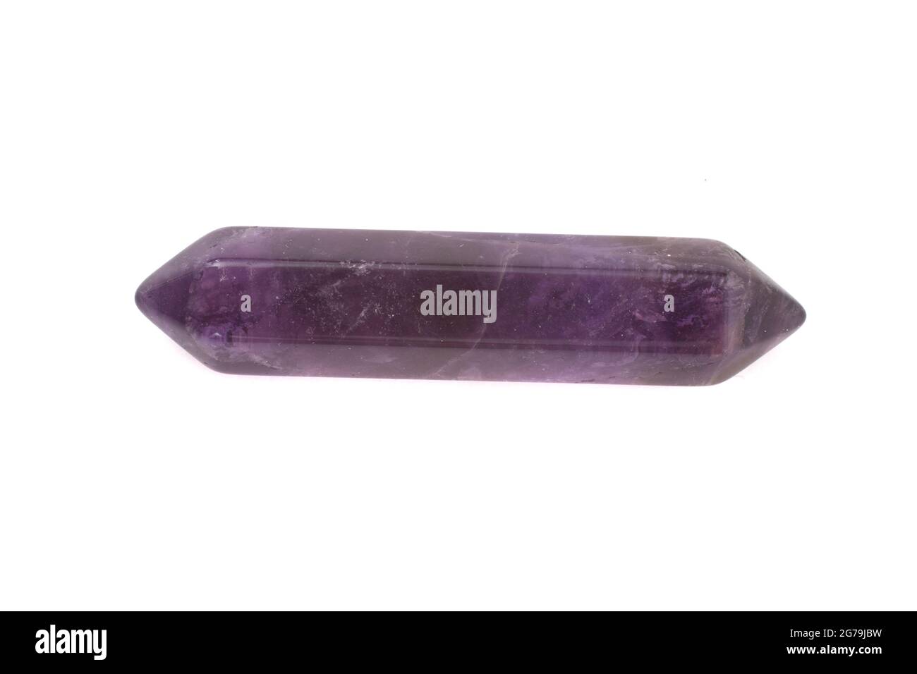 A Purple Amethyst point, gemstone used for healing photographed against a white background Stock Photo