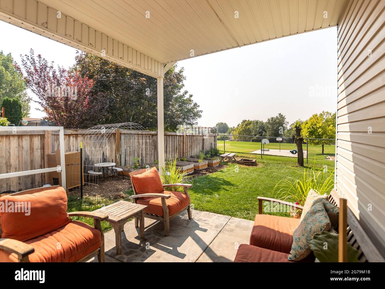 House patio with a view of a backyard with lawn and a wooden and metal ...