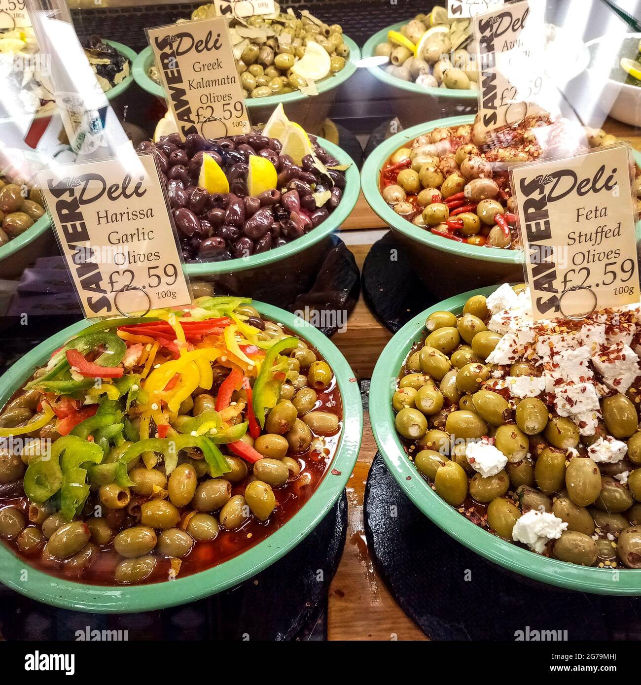 Belfast, UK, December, 2019. Variety of olives with price tags in SAWERS, a famous food shop in Belfast. Stock Photo