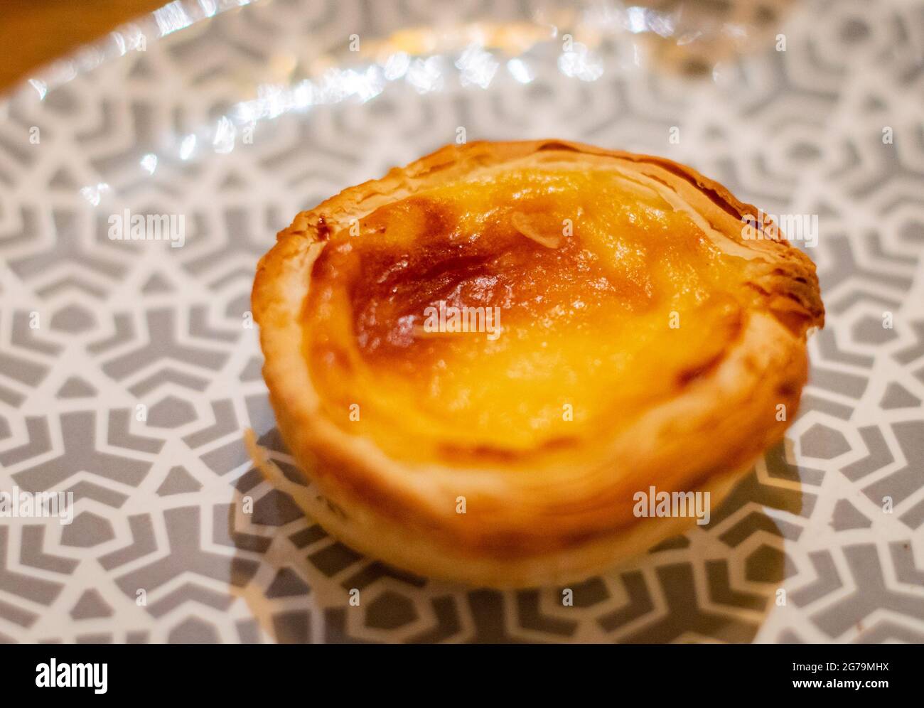 One Portuguese egg tart placed on a plate Stock Photo
