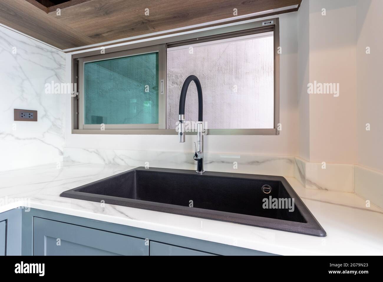 Luxurious black sink on a marble kitchen countertop Stock Photo Alamy