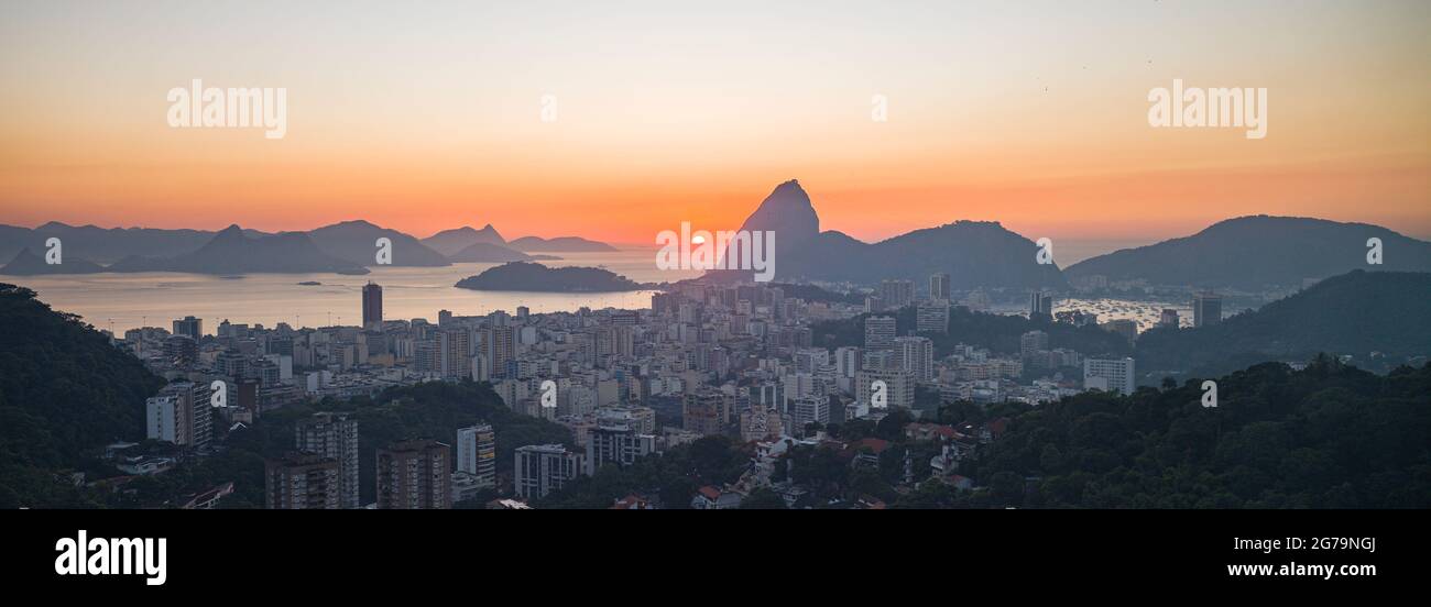 Panoramic view at sunrise of Sugarloaf Mountain (Morro pao de açúcar) and Bahia de Guanabara with the district Botafogo in Rio de Janeiro, Brazil Stock Photo