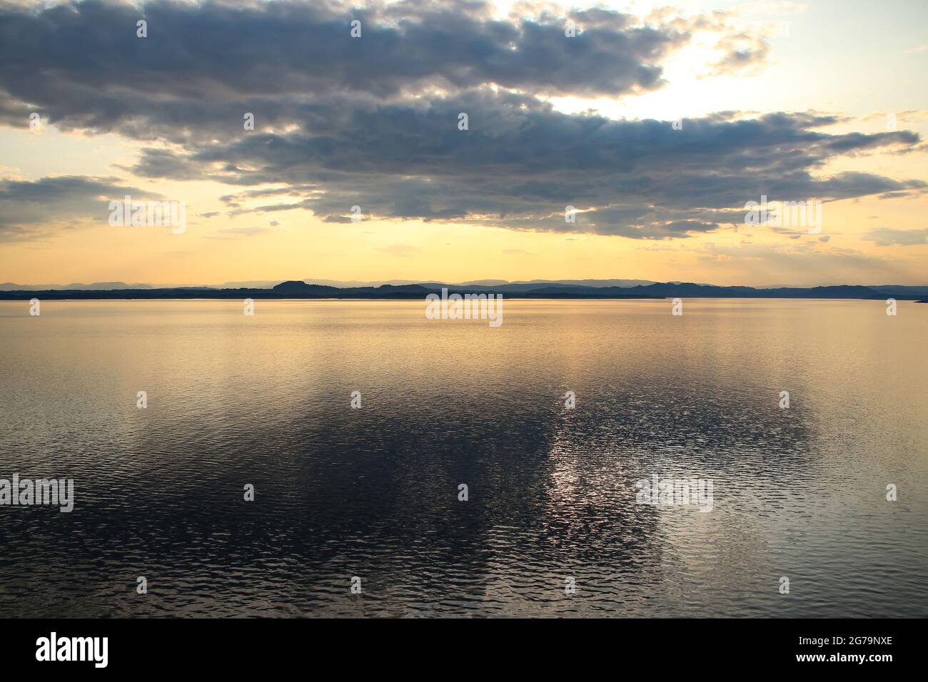 Beautiful sunrise over the ocean with sunlight shining between the clouds, Sognefjord, the country’s longest and deepest, Close to Bergen, Norway. Stock Photo