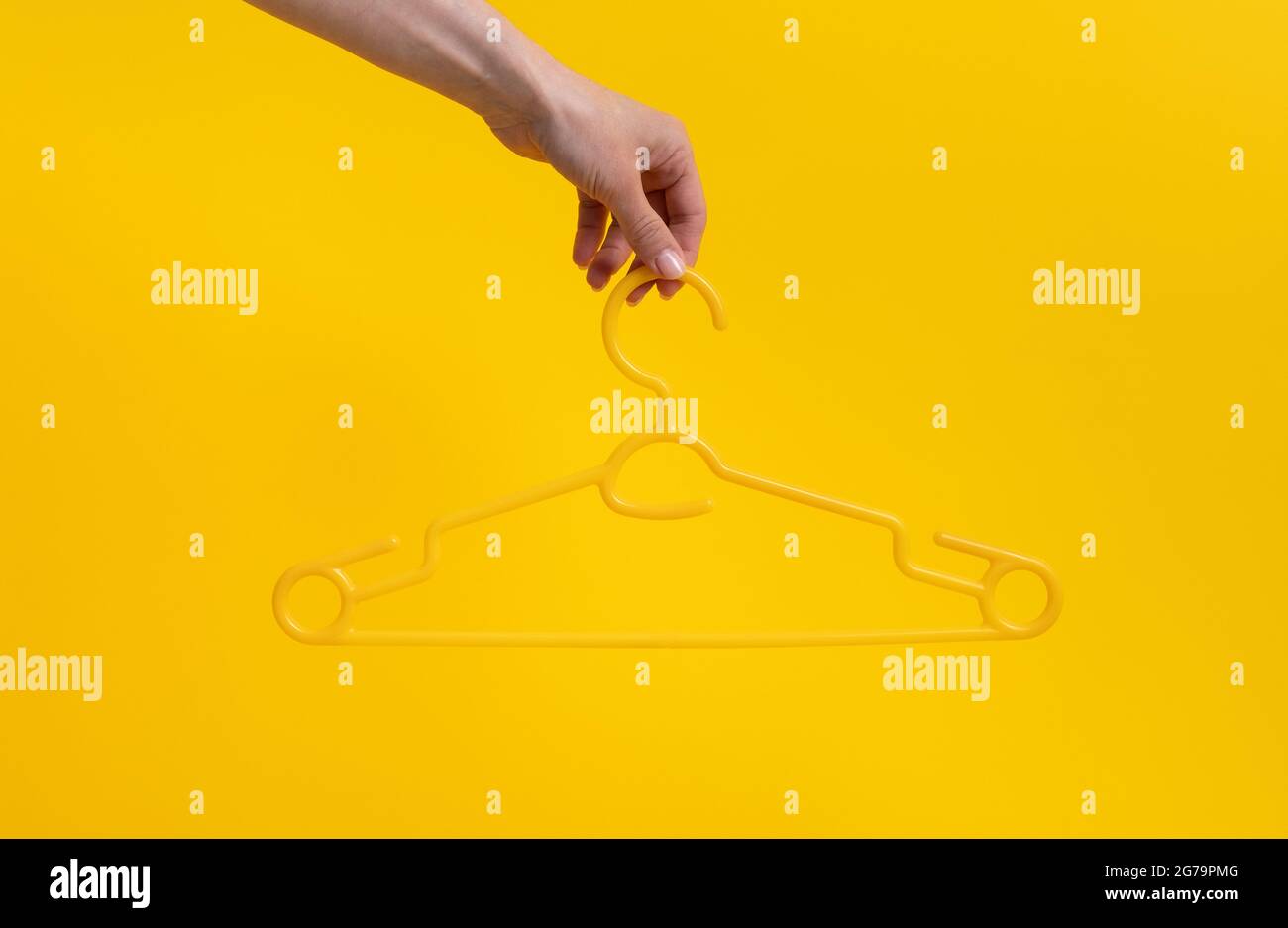 Hand holding clothes hanger hi-res stock photography and images - Alamy