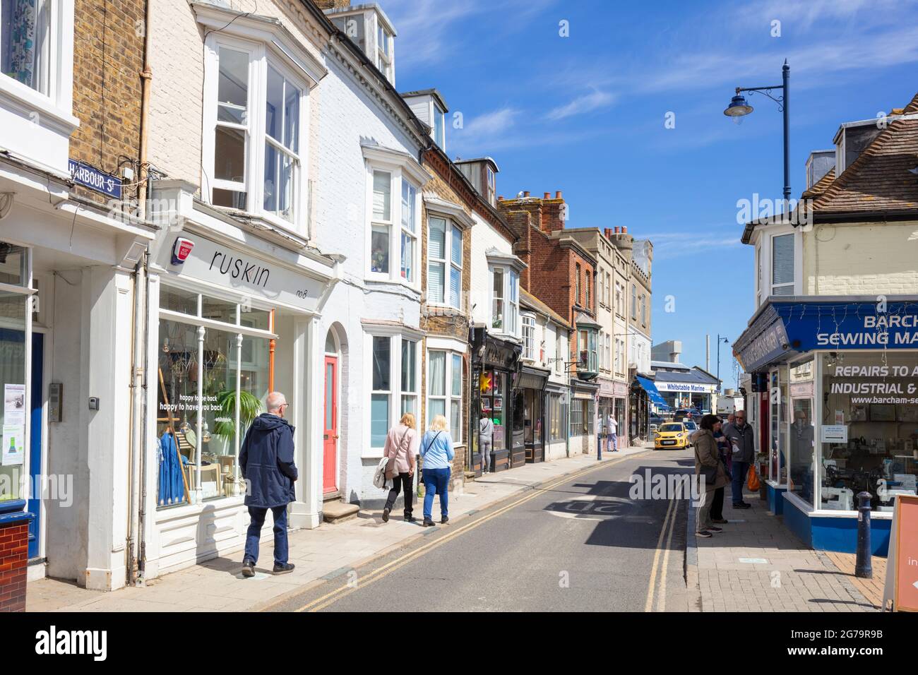 Brightly coloured Shops on Harbour Street town centre Whitstable Kent England UK GB Europe Stock Photo