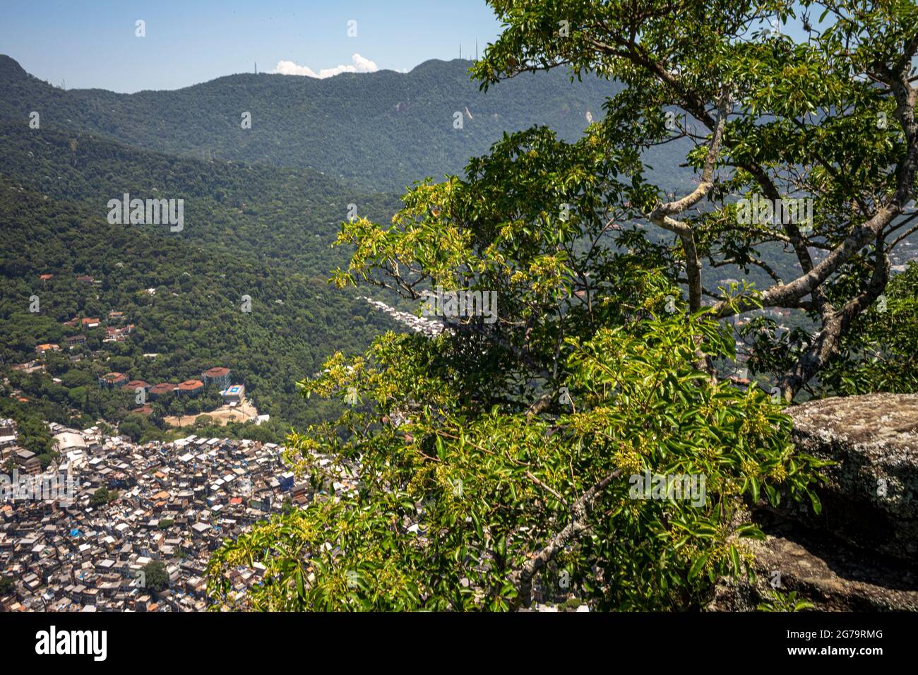 Elevated view from the cliff edge of two brothers hill (dos irmaos) with leica m10 over the Rocinha Favela - dense slum full of brick houses - in Rio de Janeiro, Brazil, from the top of Dois Irmaos Mountain. Stock Photo