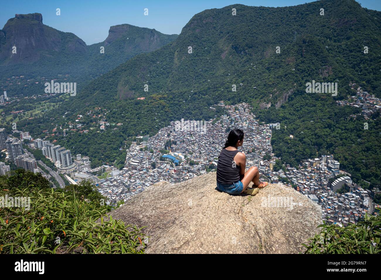 Elevated view from the cliff edge of two brothers hill (dos irmaos) with leica m10 over the Rocinha Favela - dense slum full of brick houses - in Rio de Janeiro, Brazil, from the top of Dois Irmaos Mountain. Stock Photo