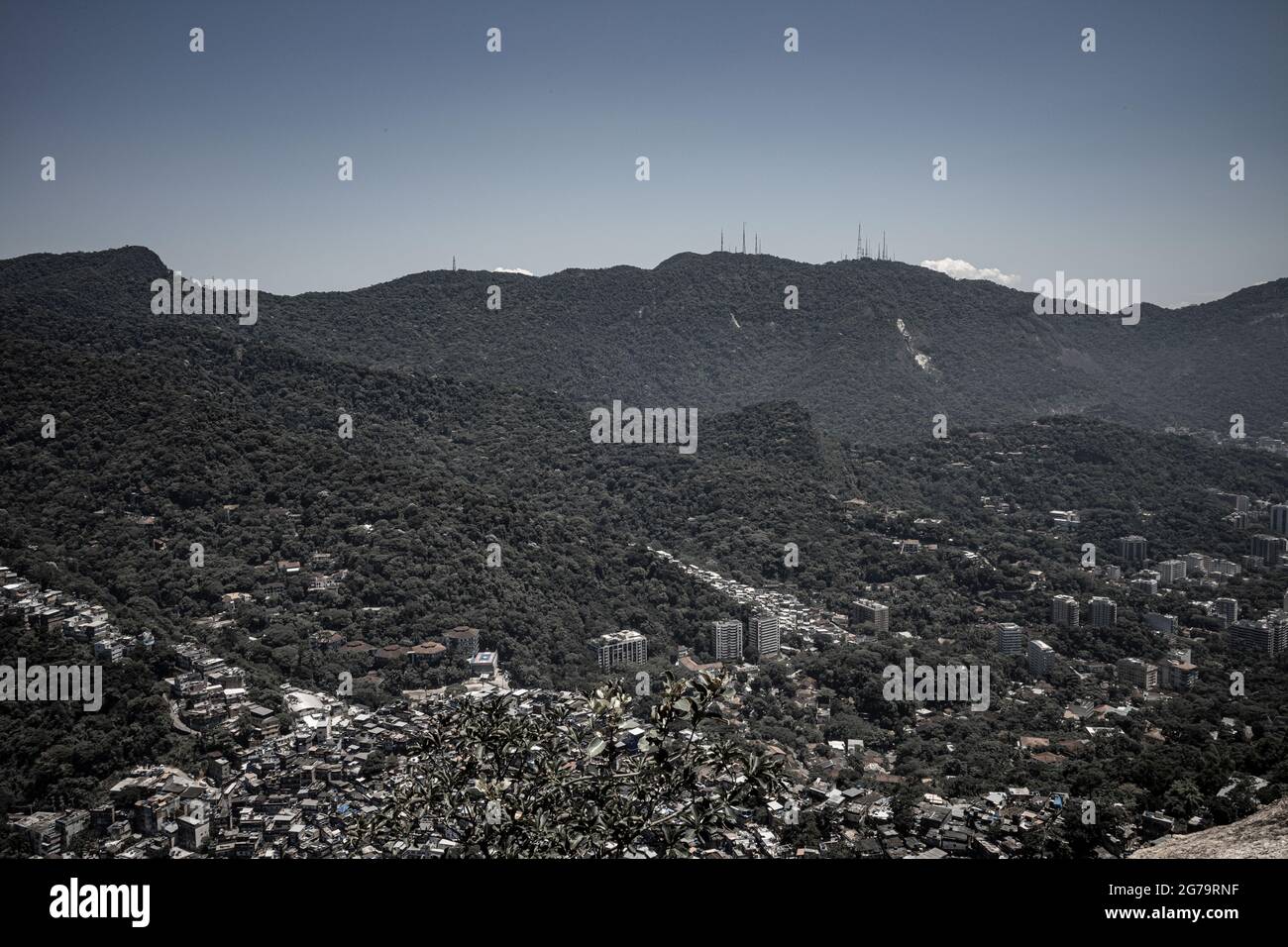 Elevated view from the cliff edge of two brothers hill (dos irmaos) with leica m10 over the Rocinha Favela - dense slum full of brick houses - in Rio de Janeiro, Brazil, from the top of Dois Irmaos Mountain. Stock Photo