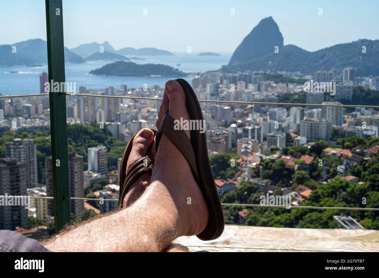 Man relaxing, view on Sugarloaf Mountain and Botafogo in Rio de Janeiro, Brazil Stock Photo