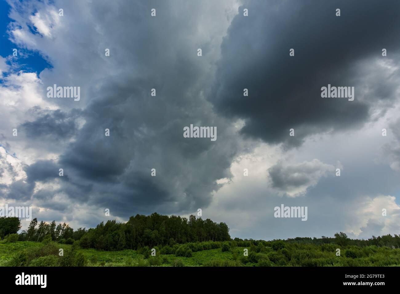 Extreme thunderstorm clouds moving over fields, climate change concept Stock Photo