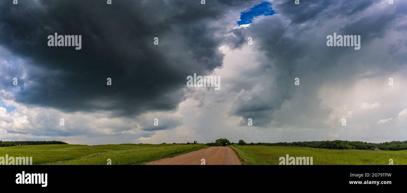 Extreme thunderstorm clouds moving over fields, climate change concept Stock Photo
