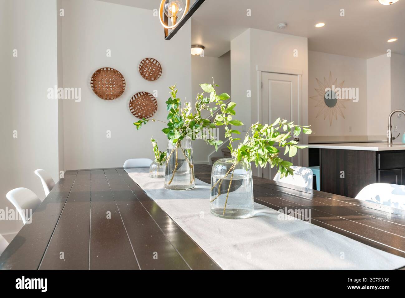 Wooden plank table top at dining area with centerpiece cloth and water