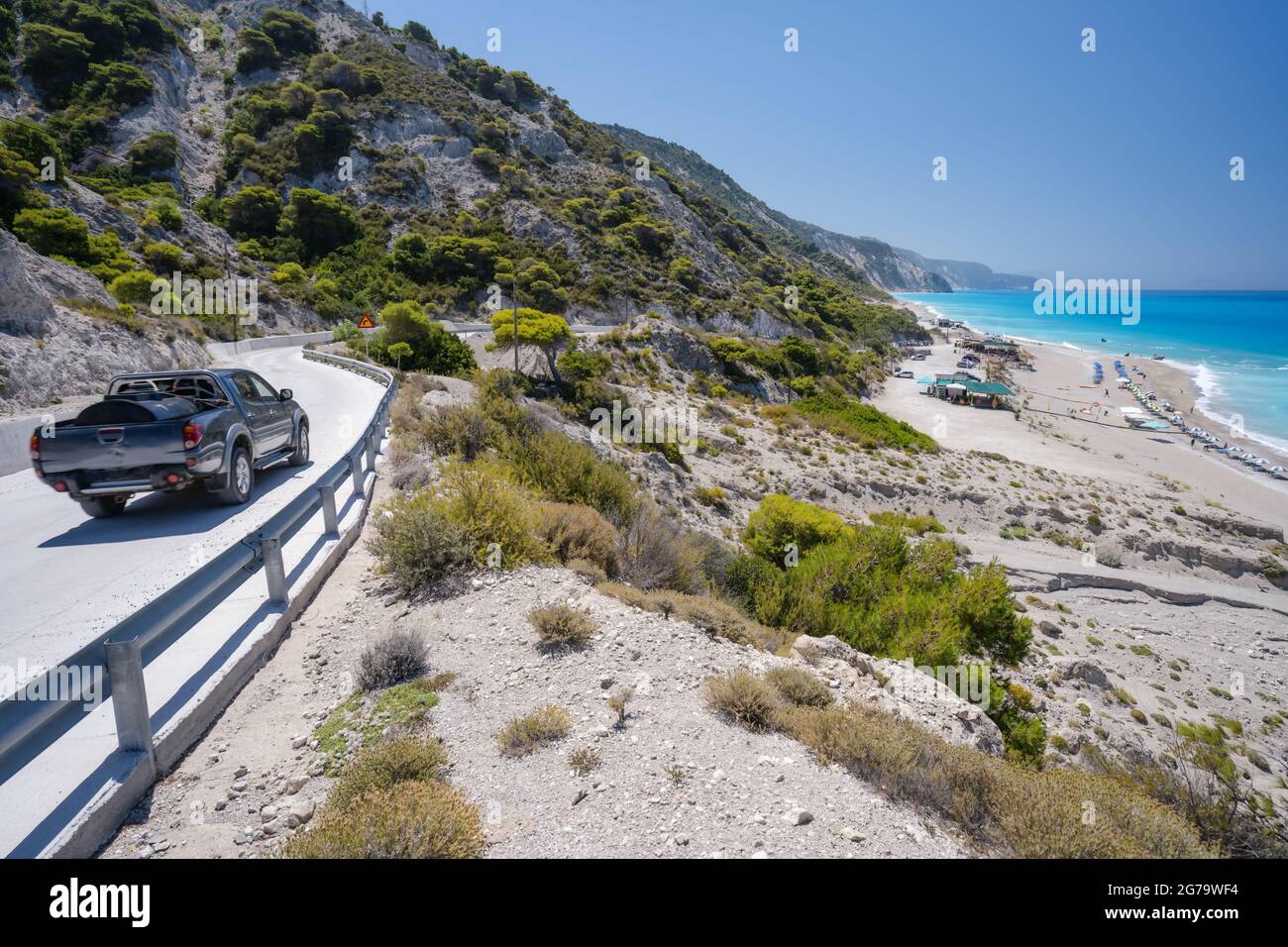 Tourist car on the coast road to beach on Lefkada Ionian island, Greece Stock Photo